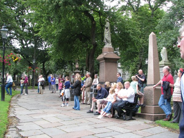 CROWD IN CEMETERY